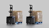 Two PUDU MP2000 robots on a plain grey background, each carrying a shrink-wrapped pallet of cartons on a blue pallet