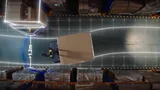 Top-down view of a PUDU MP2000 carrying a large wrapped pallet through a racked aisle, with a graphic clearance envelope and a greater-than-1.2 m measurement marking